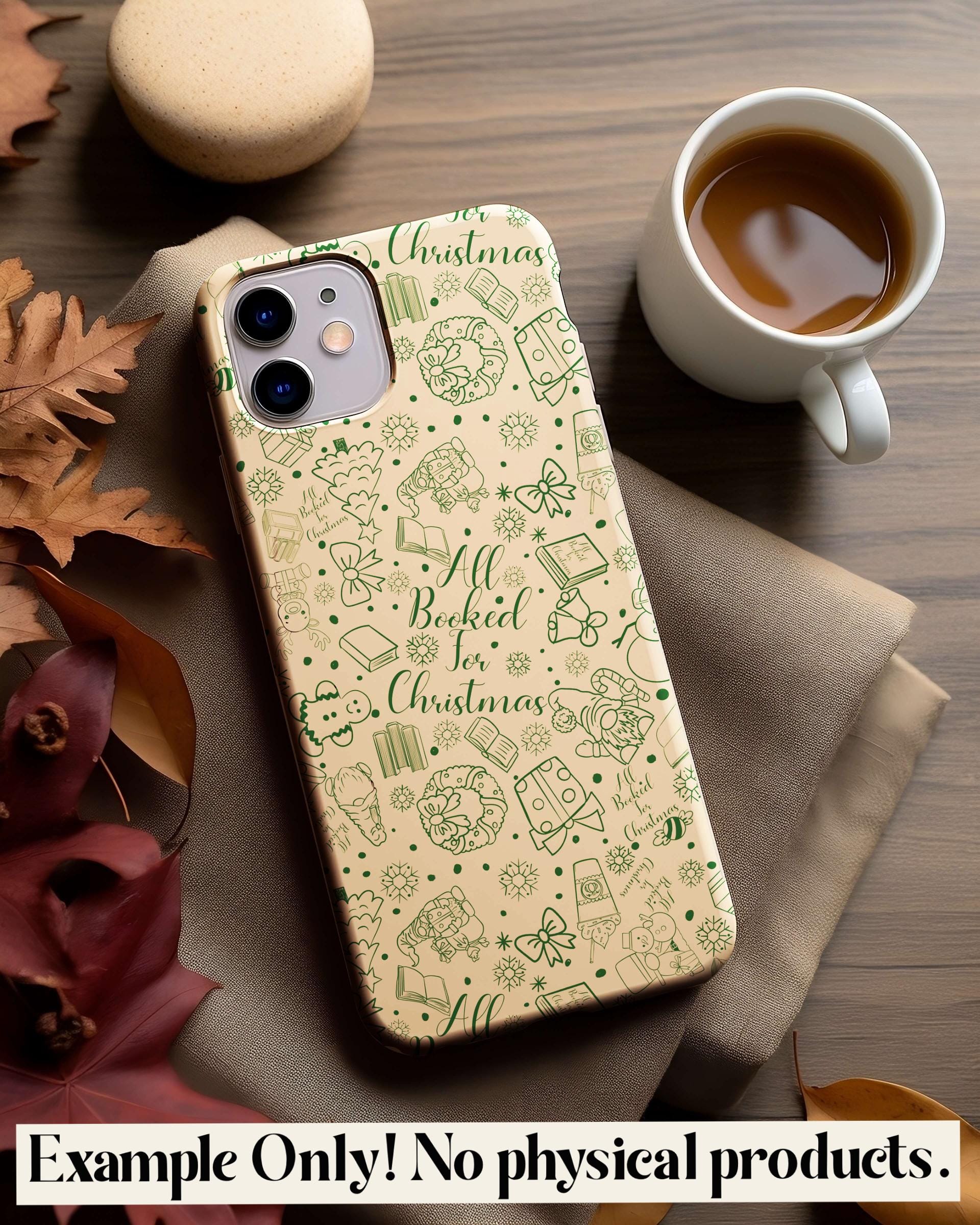 Phone case with Christmas design on a wooden table with a cup of coffee and leaves.